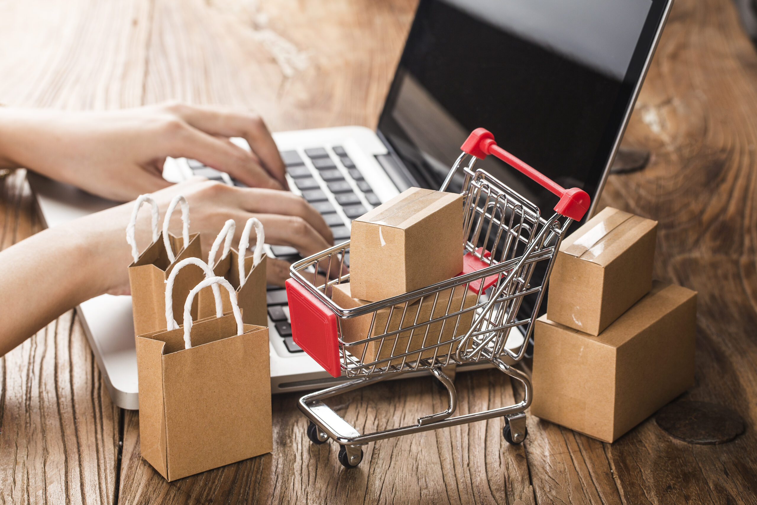 Person completing secure e-commerce payment UK online checkout on laptop