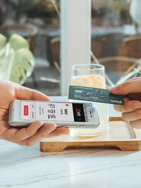 Card machine lowest fees UK PAX A50 payment terminal held by waiter