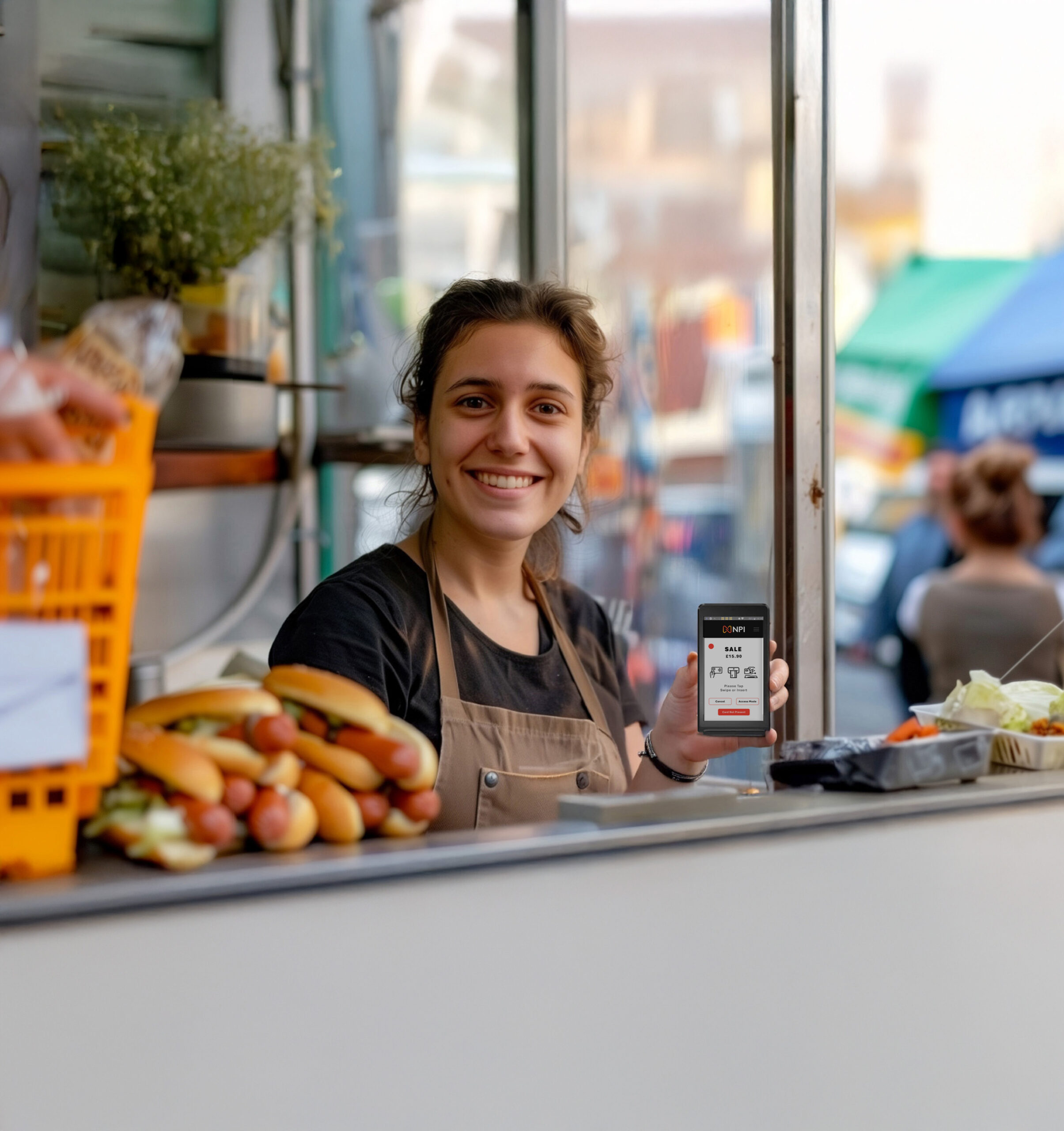 Market stall trader holding S1 MINI2 portable card machine for retail payment systems UK