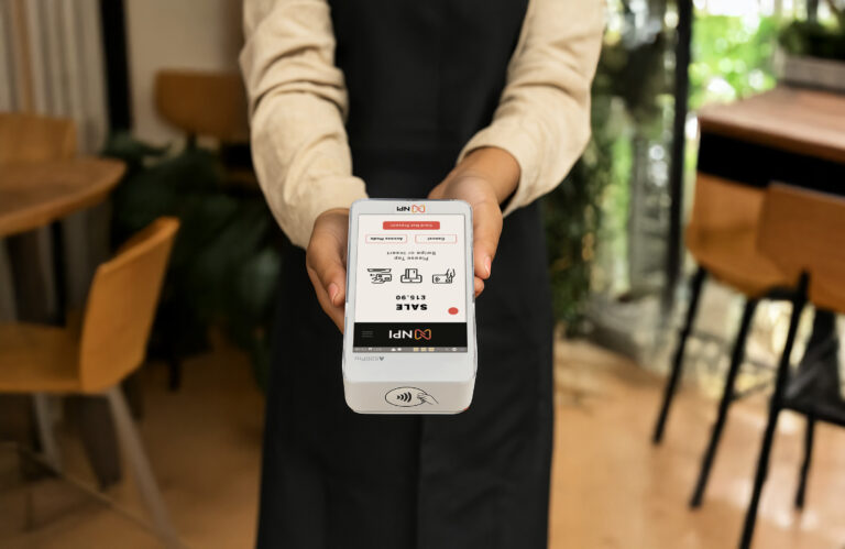 UK barista using PAX A920 PRO payment terminal in coffee shop for contactless customer payment