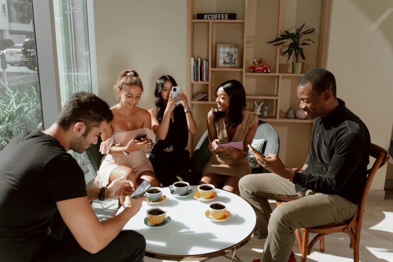 Friends enjoying coffee at UK cafe using contactless payment methods