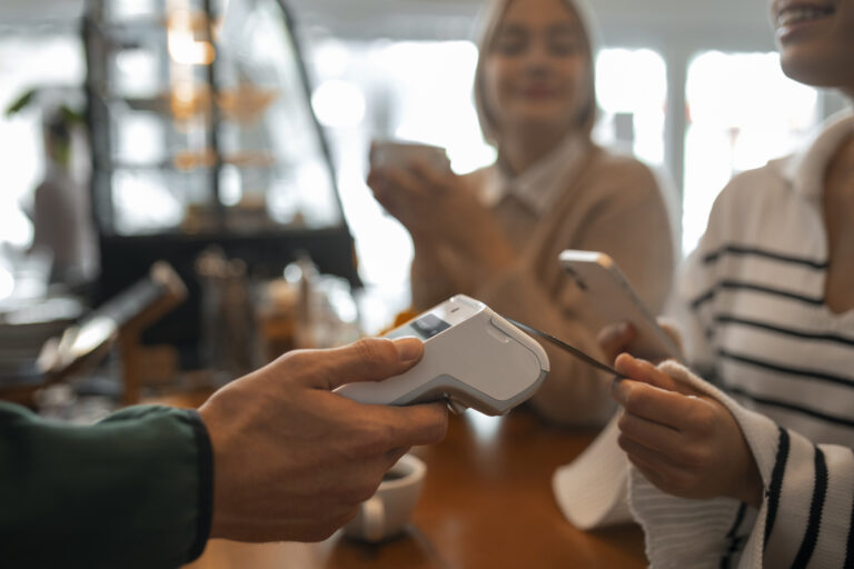 Customer making contactless payment on PAX A920 PRO terminal for multi-currency payments UK