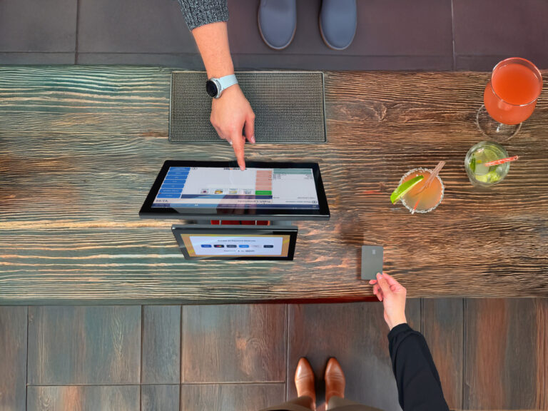 Customer making contactless payment at modern cloud EPOS UK terminal in retail store