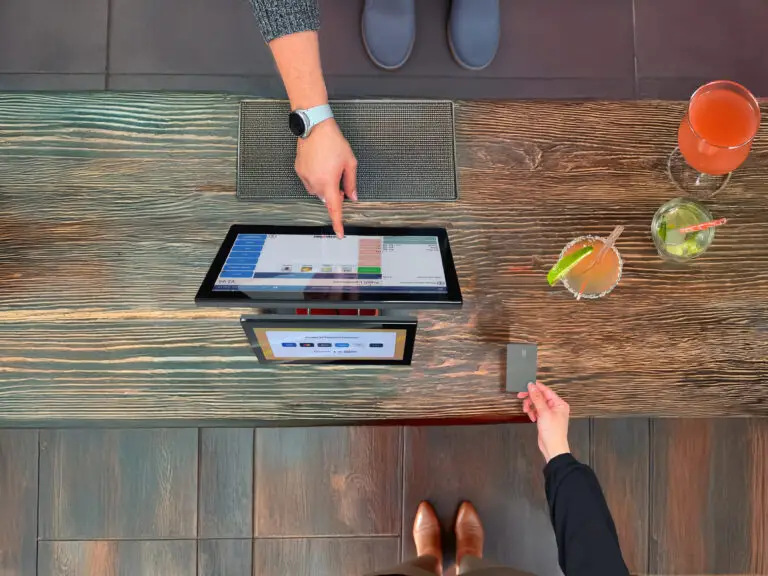 Customer making contactless payment at modern cloud EPOS UK terminal in retail store