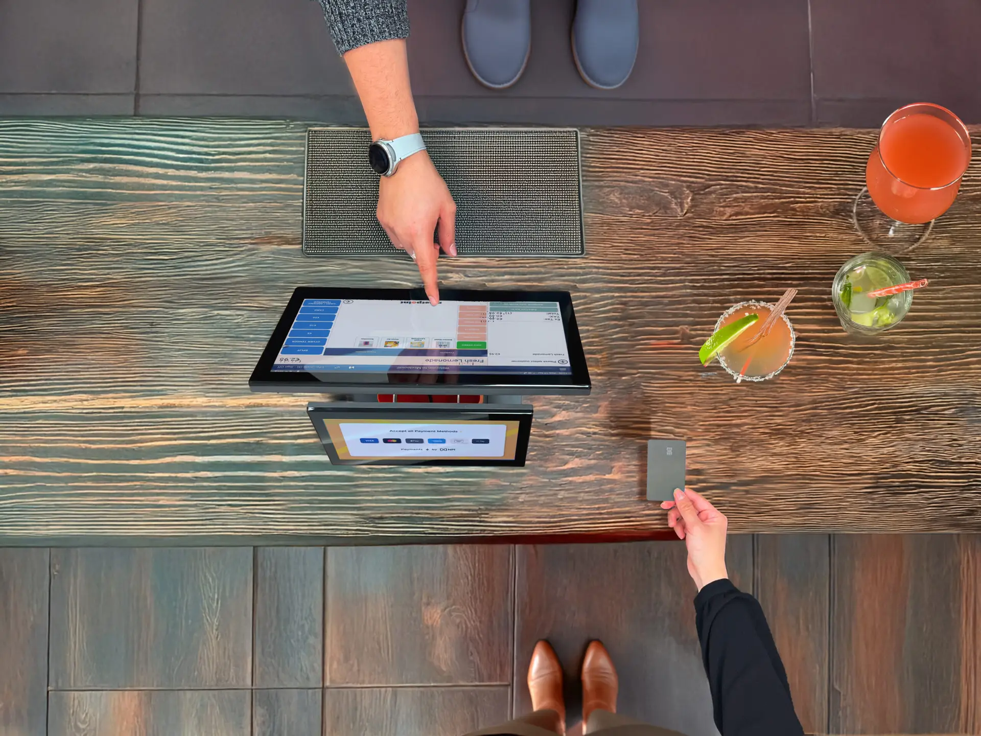 Customer making contactless payment at modern cloud EPOS UK terminal in retail store