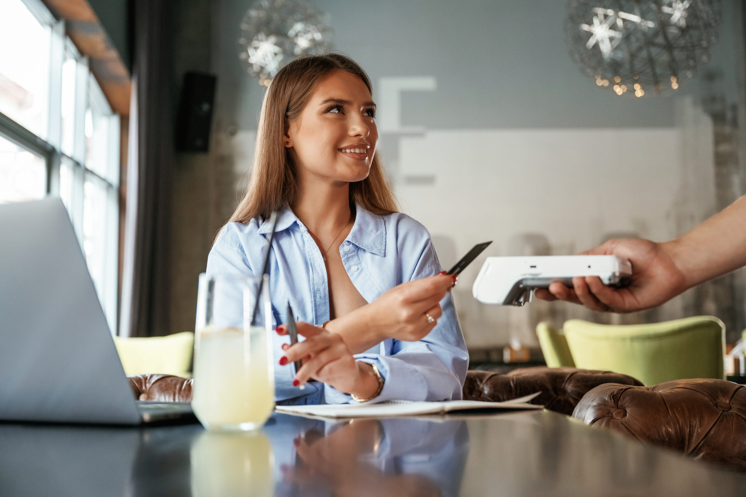 Customer making contactless payment with PCI compliant PAX A920 Pro terminal at restaurant