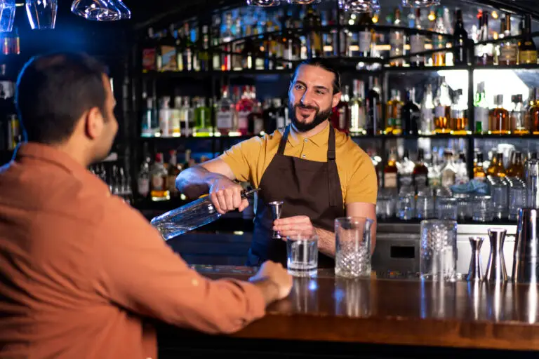 Bartender using a pub card machine UK during a busy night shift