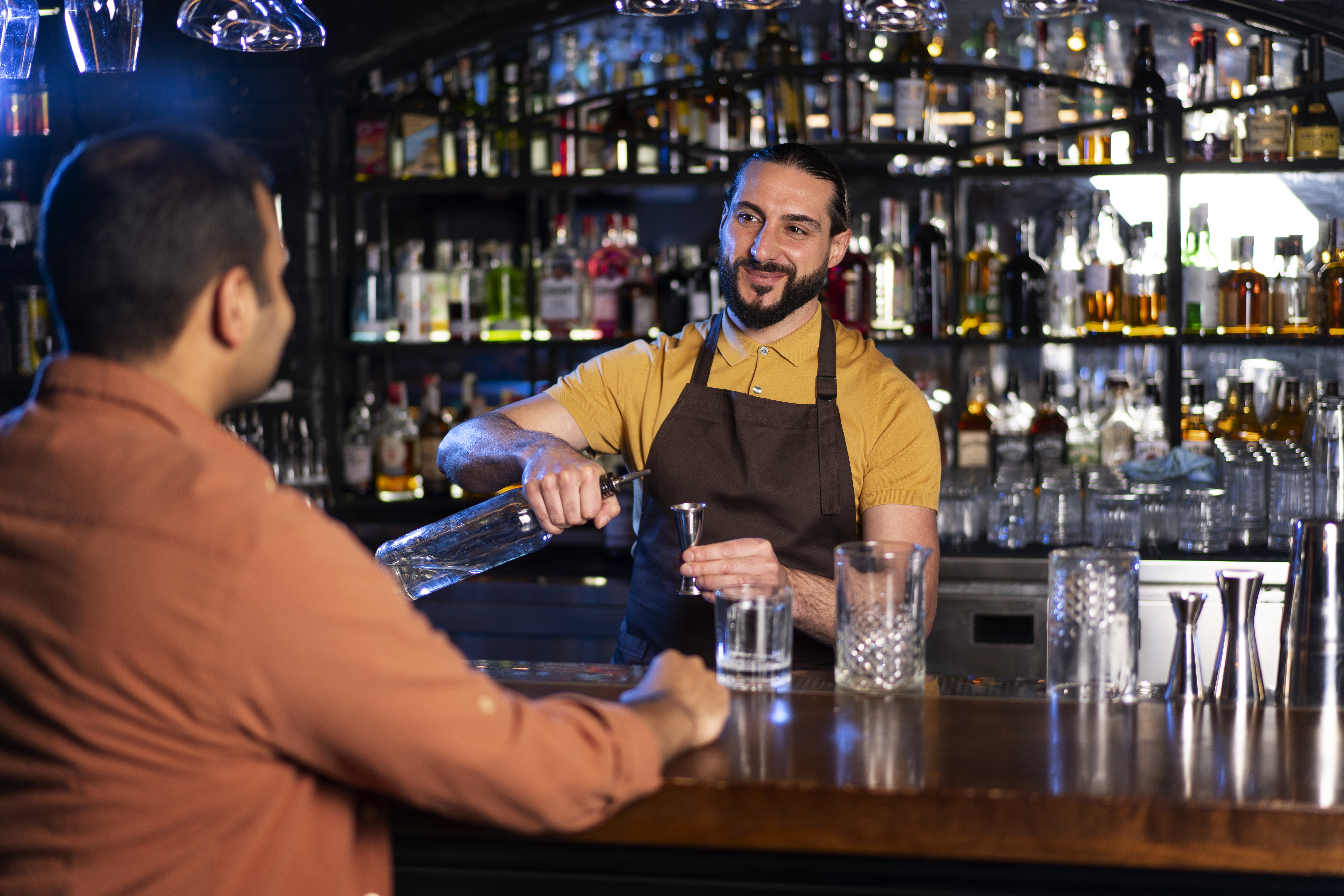Bartender using a pub card machine UK during a busy night shift
