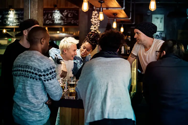 Busy UK pub on a Friday night where a card machine for pubs UK processes fast contactless payments