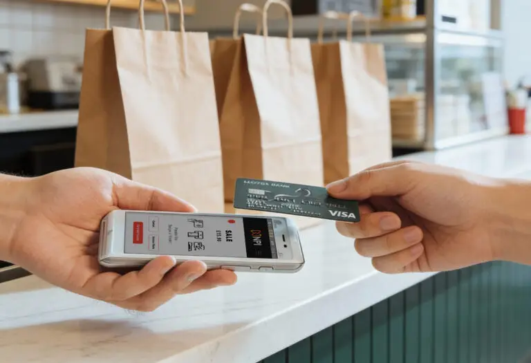 Customer making a contactless payment on a PAX A50 card machine in a UK retail store